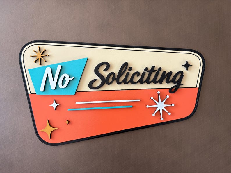 May include: A trapezoidal wall sign with a cream top and orange bottom section. It features the text No Soliciting in black and white script. The design includes turquoise and orange starburst accents, two horizontal lines, and a black border.