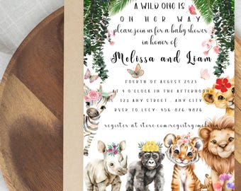 May include: A baby shower invitation with a jungle theme. The invitation features illustrations of a zebra, rhino, gorilla, tiger, and lion. The text reads "A wild one is on her way" and includes the names Melissa and Liam.