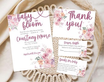 May include: Baby shower invitation set with floral accents in shades of pink and purple. The invitation reads "baby in bloom" and includes details for Courtney Moore's shower. Includes a thank you card, diaper raffle, and books for baby cards.