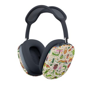 May include: Over-ear headphones with a dark gray headband and earcups. The earcups feature a cream-colored design with colorful illustrations of insects, butterflies, and plants. The headphones have a mesh interior.