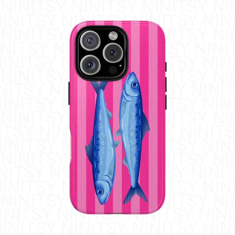 May include: A phone case with a pink striped background featuring two blue fish illustrations. The case has a glossy finish and a camera cutout.