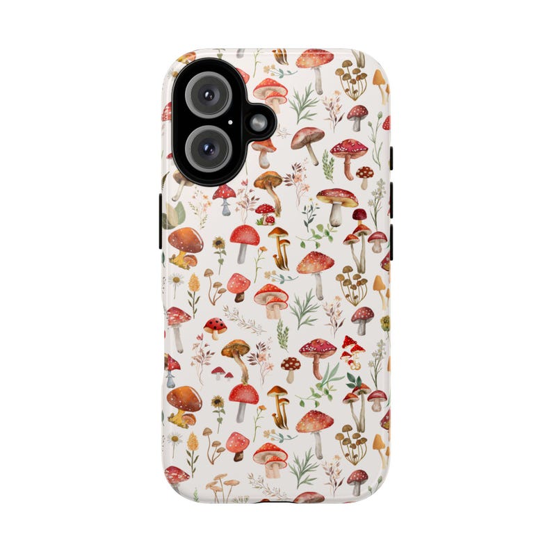 May include: A white phone case with a pattern of red and white mushrooms and green leaves.