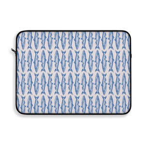 May include: Laptop sleeve featuring a repeating pattern of blue fish illustrations on a light beige background. The sleeve has a black zipper and trim, offering a nautical or coastal theme.