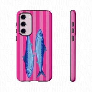 May include: A pink phone case with a vertical striped pattern and two blue fish illustrations. The case has a side view showing the buttons and the camera module.