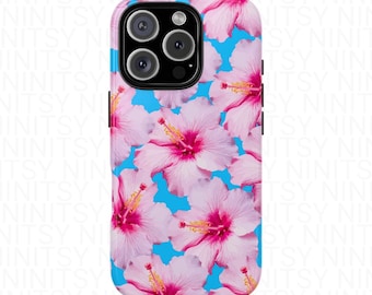 May include: A phone case featuring a vibrant floral pattern. The design showcases pink hibiscus flowers with yellow stamens against a bright blue background. The case has a glossy finish and a camera cutout.
