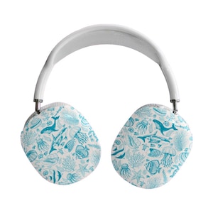 Könnte beinhalten: Weiße Over-Ear-Kopfhörer mit Ohrmuscheln mit einem hellblauen Meereslebewesen-Muster. Das Design umfasst Illustrationen von Walen, Quallen, Fischen und Korallen auf weißem Hintergrund. Das Kopfband ist weiß mit einem grauen Mesh-Innenraum.