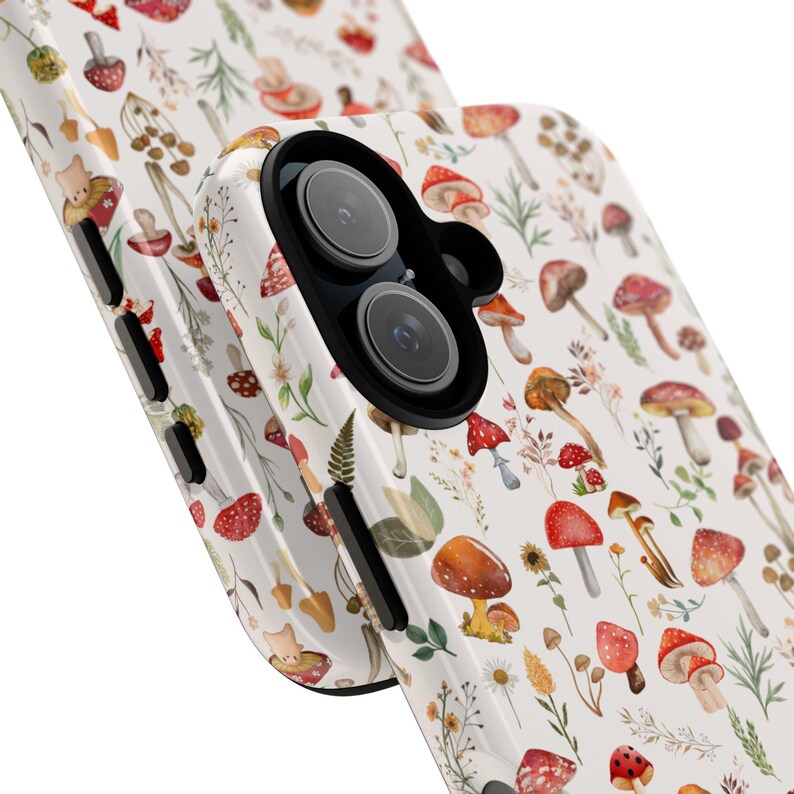 May include: A white phone case with a pattern of red and brown mushrooms, green leaves, and yellow flowers. The case has a black camera lens cutout.