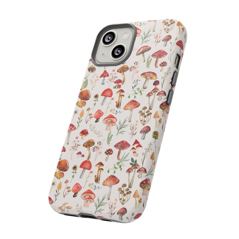 May include: A white phone case with a pattern of red and brown mushrooms on a white background. The case has a camera cutout and a white border.