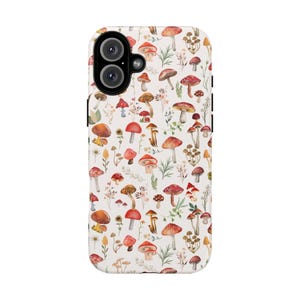 May include: A white phone case with a pattern of red and white mushrooms and green leaves.