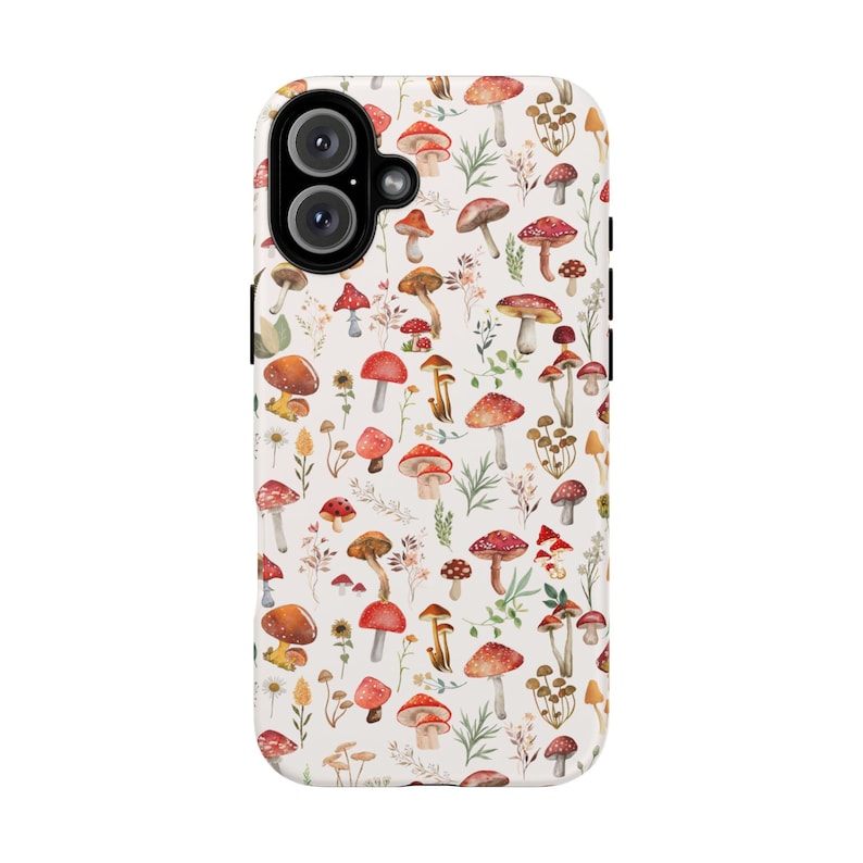 May include: A white phone case with a pattern of red and white mushrooms and green leaves.