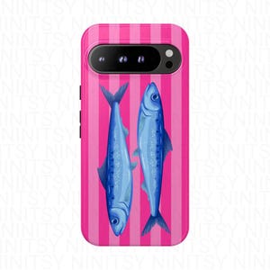 May include: A phone case featuring a pink and white striped background with two blue fish illustrations. The fish are oriented vertically, facing opposite directions. The case has a camera cutout and side buttons.