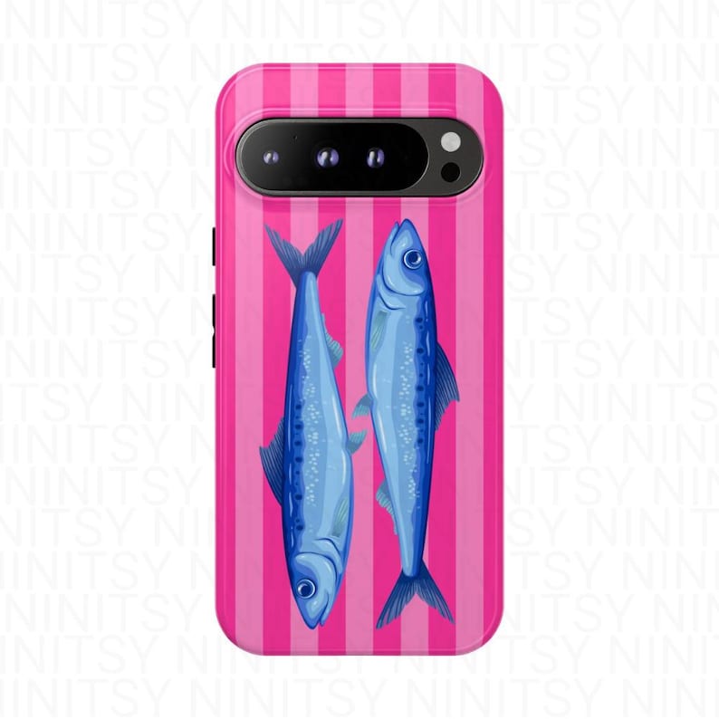 May include: A phone case featuring a pink and white striped background with two blue fish illustrations. The fish are oriented vertically, facing opposite directions. The case has a camera cutout and side buttons.