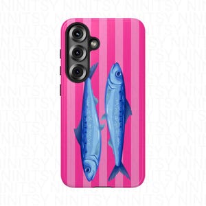 May include: A phone case featuring a vibrant pink and white striped background. Two blue fish are vertically displayed on the case. The phone case has a camera module on the upper left side.