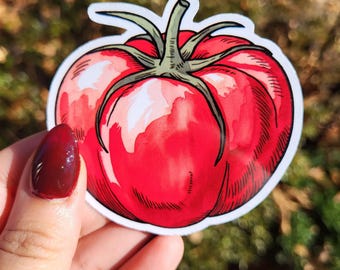 May include: A red tomato sticker with a green stem and leaves. The sticker is drawn in a watercolor style and has a white outline.