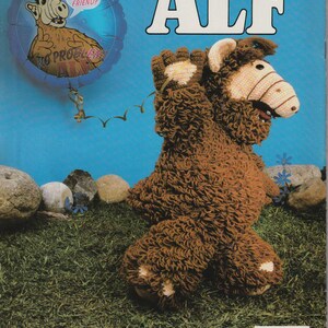 May include: A crochet pattern for a brown and white Alf puppet. The pattern is from Millcraft, Inc. The image shows the finished puppet with a blue background and a small balloon with Alf's face on it.