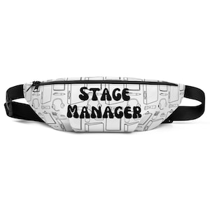 May include: A white fanny pack with a black zipper and strap. The pack features a repeating pattern of stage management tools and the words "STAGE MANAGER" in bold, black letters.