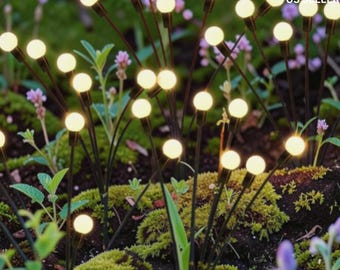 May include: A collection of outdoor garden lights featuring thin black metal stems topped with small, glowing warm white spherical bulbs. These decorative lights are arranged in a cluster, mimicking the appearance of fireflies in a garden.