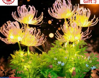 May include: A cluster of illuminated artificial flowers with yellow and white petals, set against green foliage. The image includes the text "Funny Gift :)" and a "Best Seller" badge.