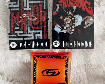 May include: Three album covers with Spotify codes. The top left cover is black and red with the text "Stray Kids Miroh". The top right cover is black with the text "Fad Song". The bottom cover is orange and red with the text "The World".