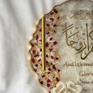 May include: A decorative resin tray with gold trim, featuring gold leaf, red rose petals, and gold Arabic calligraphy. The tray includes the text "And We created..." and two heart-shaped accents.