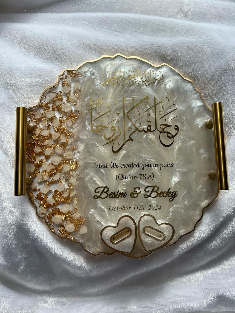 May include: A decorative resin tray with gold accents and handles. The tray features gold calligraphy and the text "And We created you in pairs" with the names "Besim & Becky" and the date "October 11th. 2024".