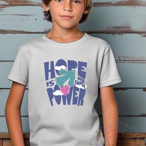May include: A light grey t-shirt with a blue graphic that says "HOPE IS MY SUPER POWER" with a blue bird holding a pink heart.