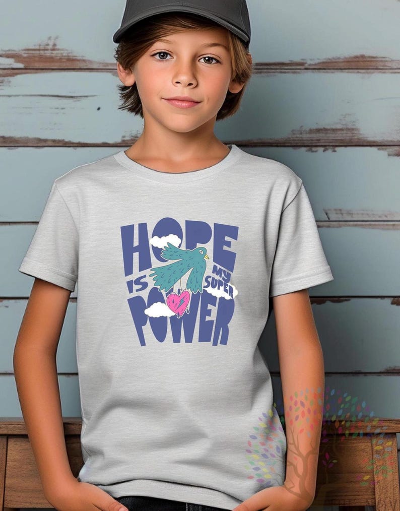 May include: A light grey t-shirt with a blue graphic that says "HOPE IS MY SUPER POWER" with a blue bird holding a pink heart.