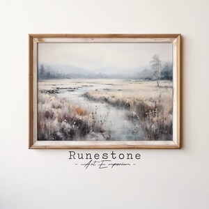 May include: A framed watercolour painting of a misty landscape with a winding river flowing through a field of tall grass. The painting is in muted tones of blue, green, and brown.