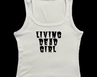 May include: White ribbed tank top with the text "LIVING DEAD GIRL" printed in black.