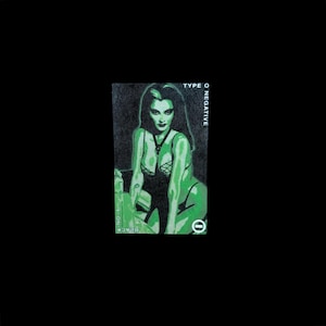 May include: A green and black illustration of a woman with long dark hair wearing a black and green lace top. The text "TYPE O NEGATIVE" is printed in white on a black background.