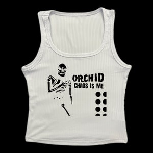 May include: White ribbed tank top with a black skeleton graphic and the text "ORCHID CHAOS IS ME" and a row of black circles.
