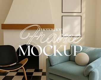 May include: Two framed pictures hang on a wall above a blue sofa and a black chair. The sofa has a white pillow. The wall is a light beige color. The room has a fireplace with a black hearth and a wooden mantel.