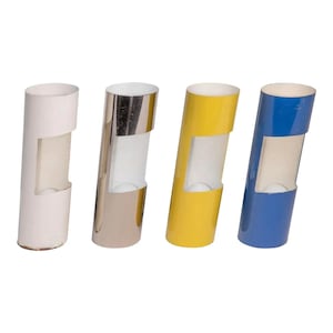May include: Four cylindrical wall sconces in white, silver, yellow, and blue. Each sconce has a rectangular opening in the middle.