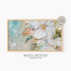 May include: A framed abstract painting with white flowers and a blue, green, and beige background. The painting is in a wooden frame.