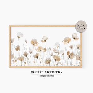 Könnte beinhalten: Ein gerahmtes Aquarellbild eines Feldes mit beigefarbenen und weißen Blumen. Das Bild ist in einem hellen Holzrahmen und hat einen weißen Hintergrund. Der Text "MOODY ARTISTRY vintage art for you" befindet sich unter dem Rahmen.