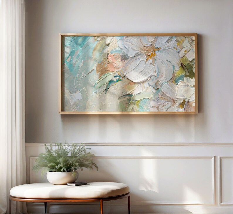 May include: Abstract painting of white flowers with a light blue and green background. The painting is framed in a gold frame.