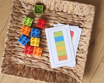 May include: A set of colorful plastic building blocks in a wicker basket with matching cards showing different colored block stacks.