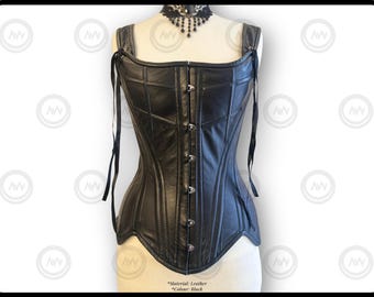 May include: Black leather corset with a square neckline and adjustable straps. The corset features a structured design with vertical and horizontal stitching, and a series of silver-toned clasps down the front. A black lace choker is also visible.