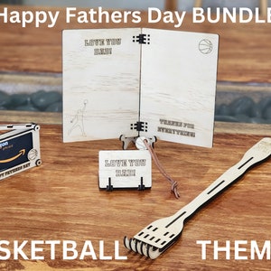 May include: A Father's Day gift bundle with a basketball theme. The bundle includes a wooden card with the text "Love You Dad!" and "Thanks for Everything!" on the inside, a wooden gift card holder with an Amazon gift card inside, a small wooden sign with the text "Love You Dad!" and a wooden basketball back scratcher.