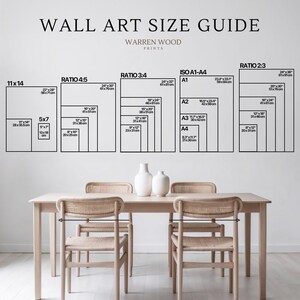May include: A wall art size guide with various aspect ratios and dimensions, including 11x14 inches, 5x7 inches, and ISO A1-A4 sizes. The guide is displayed above a wooden table with chairs and decorative vases.