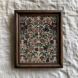 May include: A framed floral print with a dark brown wooden frame. The print features a repeating pattern of flowers in shades of burgundy, peach, and green on a cream background. The text "WARREN WOOD PRINTS" is at the bottom.