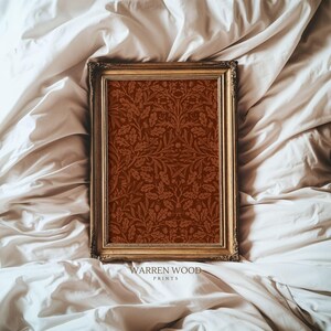 May include: A framed print featuring a detailed botanical pattern in shades of brown and rust. The print is set within a gold-colored ornate frame. The text "WARREN WOOD PRINTS" is printed at the bottom of the frame.