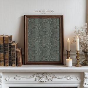 May include: A framed print with a dark teal floral pattern, displayed on a white mantelpiece. The frame is a dark brown wood. The text "WARREN WOOD PRINTS" is at the top of the frame. Lit candles and antique books are also on the mantel.