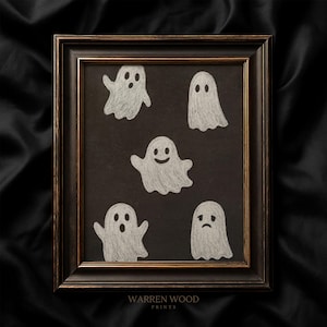 May include: Framed artwork featuring five white ghost illustrations on a black background. The ghosts have various expressions, including happy and sad faces. The frame is dark brown with a gold inner edge. The text "WARREN WOOD PRINTS" is at the bottom.
