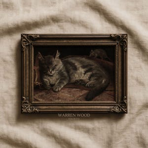 May include: A framed vintage print featuring a sleeping gray tabby cat and a small mouse. The artwork is in a dark, ornate frame. The print is signed "WARREN WOOD PRINTS".