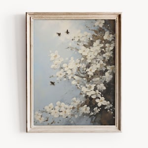 Può includere: Un dipinto incorniciato di un ramo di albero fiorito bianco su uno sfondo blu chiaro. Il dipinto presenta diverse piccole api scure che volano intorno ai fiori.