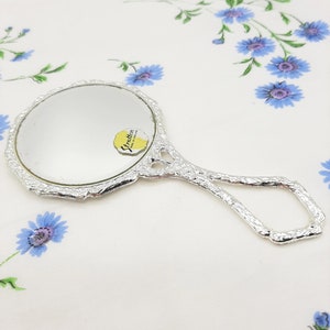 Espejo de mano Stratton vintage adornado en plata con diseño de rosa