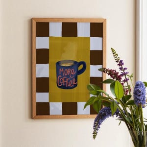 Hand-illustrated More Coffee print featuring a steaming navy blue mug and bold checkered border in chocolate brown and powder blue. Perfect kitchen wall art or gift for coffee lovers. Giclée printed to last.