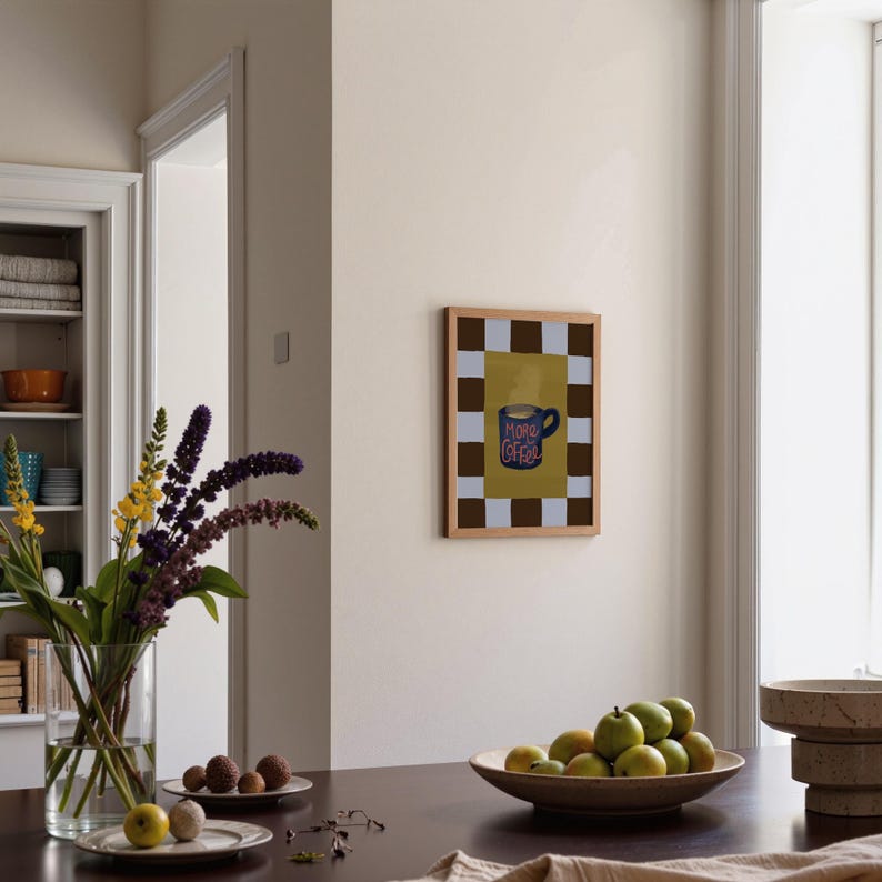 a cozy dining area with a wooden table set with a vase of purple flowers, a bowl of fruit, and a framed picture on the wall.