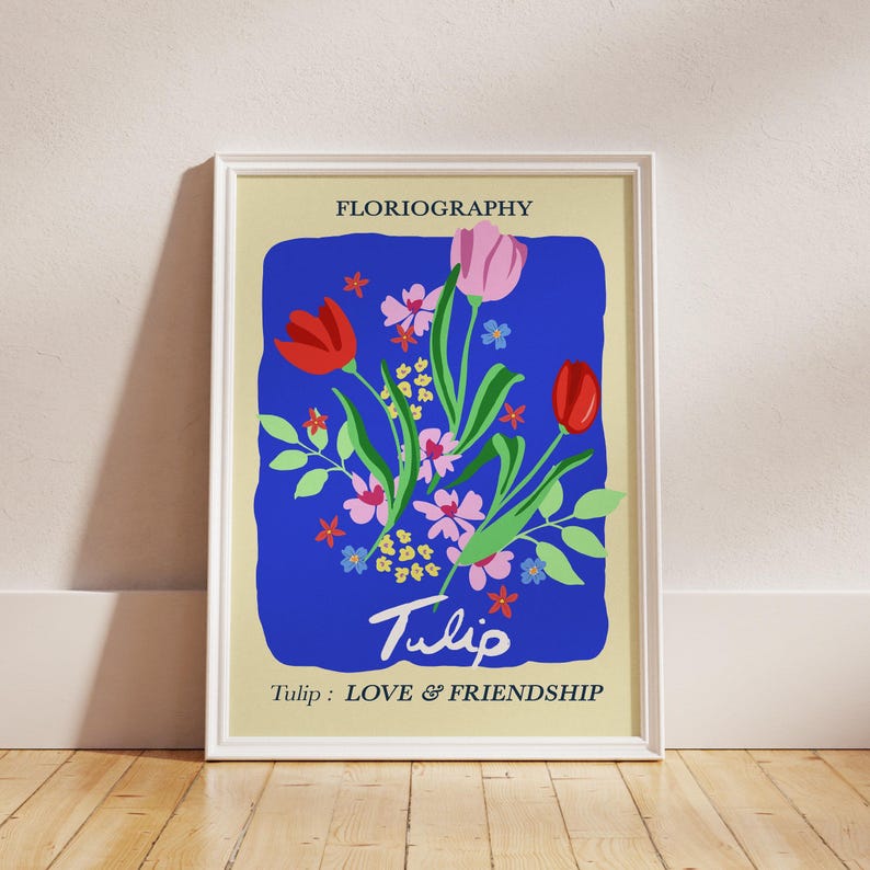 A print showing a graphic and bright illustration of a bunch of pink and red tulips on a bright blue background. In Floriography, the Language of Flowers, Tulips represent Love and Friendship.